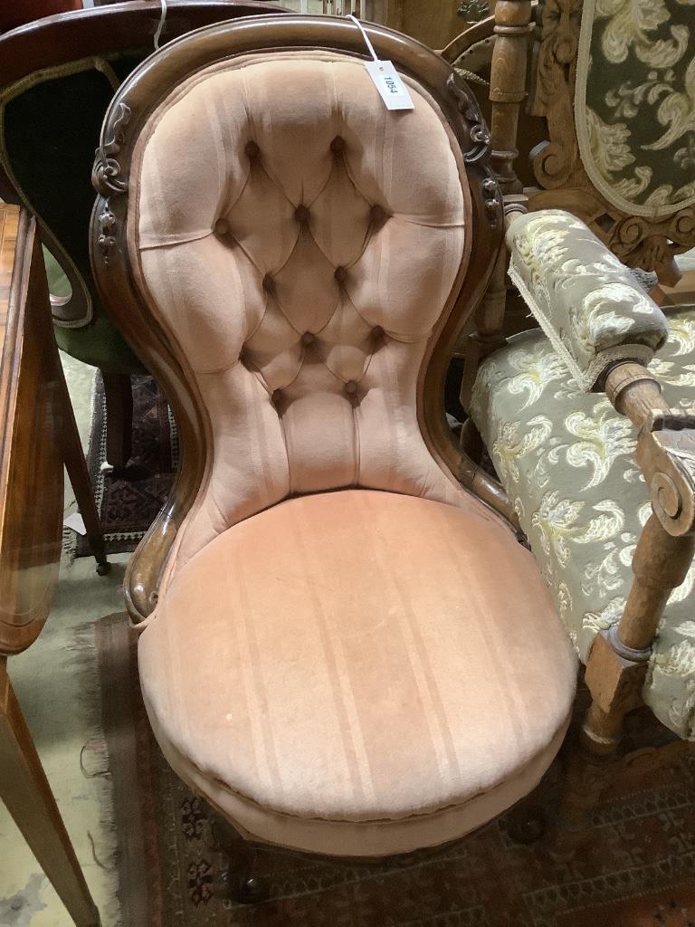 A Victorian mahogany buttonback nursing chair and a carved oak armchair